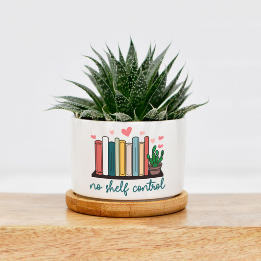 mini ceramic planter with a bookshelf design and "no shelf control" printed directly onto the planter. Available in mini and small size. Plant not included