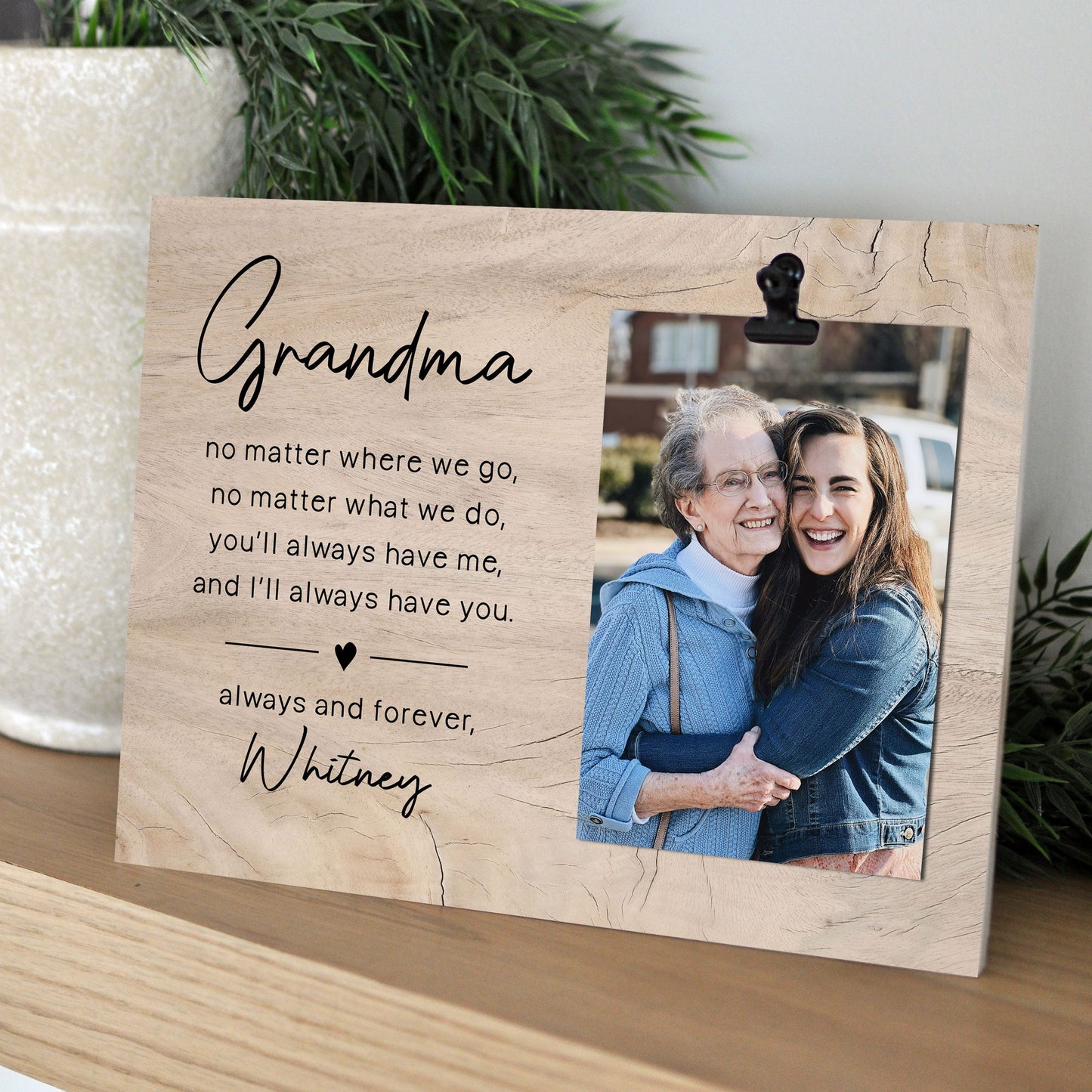 Personalized photo frame with a photo of a woman and an elderly woman, and a heartfelt message on a wooden surface.